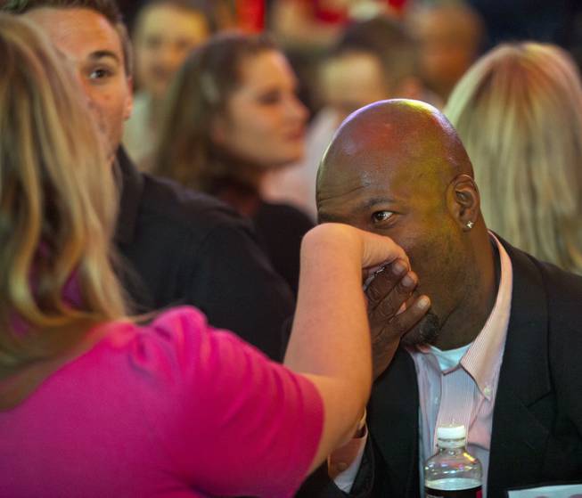 Carl Dobbins kisses the hand of Jessica Kruze as they talk across the table from each other at the D Date-a-thon outside the D Las Vegas along the Fremont Street Experience on Friday, Feb. 14, 2014.  L.E. Baskow